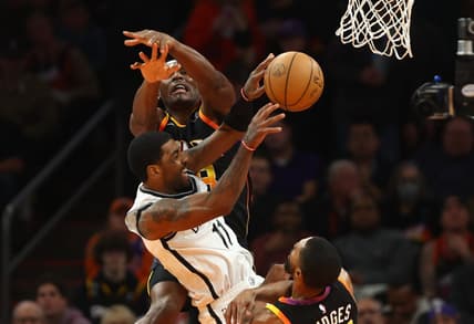 Jan 19, 2023; Phoenix, Arizona, USA; Brooklyn Nets guard Kyrie Irving (11) passes the ball against Phoenix Suns center Bismack Biyombo in the first half at Footprint Center. Mandatory Credit: Mark J. Rebilas-USA TODAY Sports