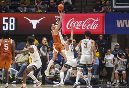 Jan 21, 2023; Morgantown, West Virginia, USA; Texas Longhorns forward Timmy Allen (0) shoots over West Virginia Mountaineers guard Erik Stevenson (10) during the second half at WVU Coliseum. Mandatory Credit: Ben Queen-USA TODAY Sports