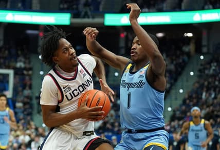 Feb 7, 2023; Hartford, Connecticut, USA; UConn Huskies guard Tristen Newton (2) drives the ball against Marquette Golden Eagles guard Kam Jones (1) in the first half at XL Center. Mandatory Credit: David Butler II-USA TODAY Sports