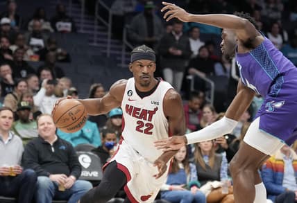 Feb 25, 2023; Charlotte, North Carolina, USA; Miami Heat forward Jimmy Butler (22) drives against Charlotte Hornets center Mark Williams (5) in the first quarter at Spectrum Center. Mandatory Credit: David Yeazell-USA TODAY Sports