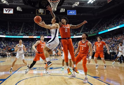 Mar 10, 2023; Greensboro, NC, USA; Virginia Cavaliers guard Kihei Clark (0) drives to the basket against Clemson Tigers guard Brevin Galloway (11) during the first half of the semifinals of the ACC tournament at Greensboro Coliseum. Mandatory Credit: John David Mercer-USA TODAY Sports