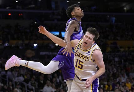 Apr 9, 2023; Los Angeles, California, USA;  Los Angeles Lakers guard Austin Reaves (15) is fouled by Utah Jazz guard Ochai Agbaji (30) as he drives for a basket in the first half at Crypto.com Arena. Mandatory Credit: Jayne Kamin-Oncea-USA TODAY Sports