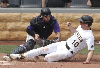 May 10, 2023; Pittsburgh, Pennsylvania, USA;  Colorado Rockies catcher Austin Wynns (16) tags Pittsburgh Pirates left fielder Bryan Reynolds (10) out at home plate attempting to score during the sixth inning at PNC Park. Mandatory Credit: Charles LeClaire-USA TODAY Sports
