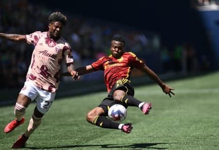 Jun 3, 2023; Seattle, WA, USA; Seattle Sounders defender Nouhou Tolo (5) clears the ball away from Portland Timbers forward Dairon Asprilla (27) in a MLS game at Lumen Field. Mandatory Credit: Steven Bisig-USA TODAY Sports
