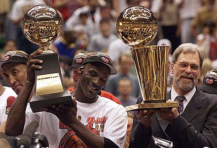 Michael Jordan holds the MVP trophy and coach Phil Jackson holds the championship trophy after the Bulls beat the Jazz to win their sixth title in 1998.

Xxx C03 Phil Jackson 17 S Ut