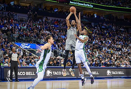 Dec 7, 2021; Dallas, Texas, USA; Brooklyn Nets forward Kevin Durant (7) shoots over Dallas Mavericks center Dwight Powell (7) and forward Reggie Bullock (25) during the second half at the American Airlines Center. Mandatory Credit: Jerome Miron-USA TODAY Sports