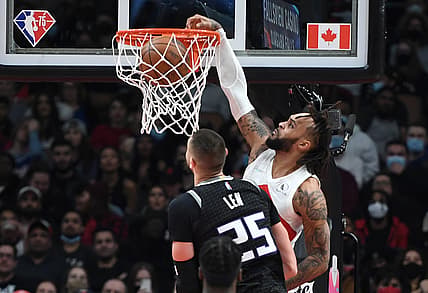 Dec 13, 2021; Toronto, Ontario, CAN; Toronto Raptors guard Gary Trent Jr. (33) dunks for a basket over Sacramento Kings center Alex Len (25) in the first half at Scotiabank Arena. Mandatory Credit: Dan Hamilton-USA TODAY Sports