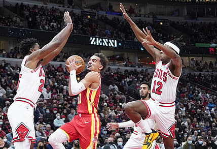 Dec 29, 2021; Chicago, Illinois, USA; Atlanta Hawks guard Trae Young (11) is defended by Chicago Bulls guard Ayo Dosunmu (12) during the second half at United Center. Mandatory Credit: David Banks-USA TODAY Sports