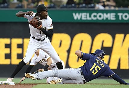 Aug 3, 2022; Pittsburgh, Pennsylvania, USA;  Pittsburgh Pirates shortstop Oneil Cruz (15) looks to throw to first base after a force out of Milwaukee Brewers center fielder Tyrone Taylor (15) at second base during the second inning at PNC Park. Mandatory Credit: Charles LeClaire-USA TODAY Sports