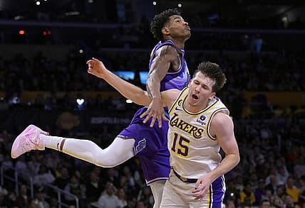 Apr 9, 2023; Los Angeles, California, USA;  Los Angeles Lakers guard Austin Reaves (15) is fouled by Utah Jazz guard Ochai Agbaji (30) as he drives for a basket in the first half at Crypto.com Arena. Mandatory Credit: Jayne Kamin-Oncea-USA TODAY Sports