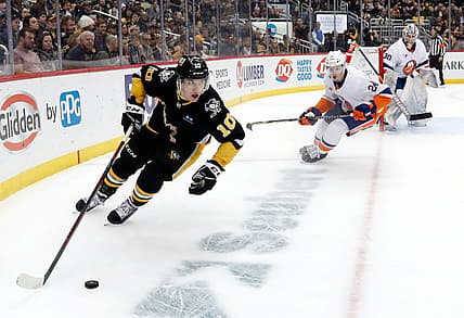 Mar 9, 2023; Pittsburgh, Pennsylvania, USA;  Pittsburgh Penguins left wing Drew O'Connor (10) moves the puck against the New York Islanders during the first period at PPG Paints Arena. Mandatory Credit: Charles LeClaire-USA TODAY Sports