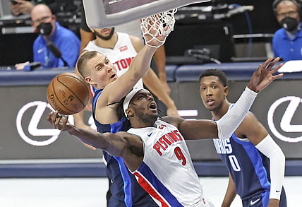 Apr 21, 2021; Dallas, Texas, USA;  Detroit Pistons forward Jerami Grant (9) shoots as Dallas Mavericks center Kristaps Porzingis (6) defends during the third quarter at American Airlines Center. Mandatory Credit: Kevin Jairaj-USA TODAY Sports