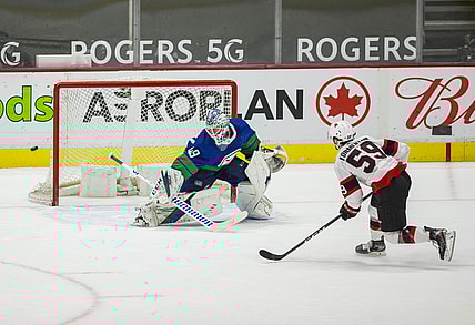 Apr 24, 2021; Vancouver, British Columbia, CAN; Vancouver Canucks goalie Braden Holtby (49) makes a save on a penalty shot attempt taken by Ottawa Senators forward Alex Formenton (59) in the second period at Rogers Arena. Canucks won 4-2.  Mandatory Credit: Bob Frid-USA TODAY Sports