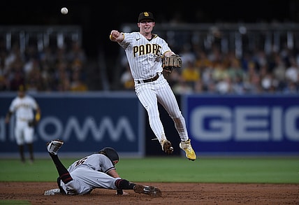 Aug 6, 2021; San Diego, California, USA; San Diego Padres shortstop Jake Cronenworth (top) throws to first base to complete a double play after forcing out Arizona Diamondbacks second baseman Jake Hager (16) at second base during the third inning at Petco Park. Mandatory Credit: Orlando Ramirez-USA TODAY Sports