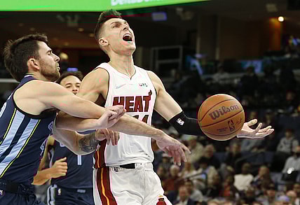 Oct 30, 2021; Memphis, Tennessee, USA; Miami Heat guard Tyler Herro (14) is fouled by Memphis Grizzlies guard John Konchar (46) in the second quarter at FedExForum. Mandatory Credit: Tim Heitman-USA TODAY Sports