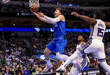 Oct 31, 2021; Dallas, Texas, USA;  Dallas Mavericks guard Luka Doncic (77) shoots past Sacramento Kings guard Davion Mitchell (15) during the first half at American Airlines Center. Mandatory Credit: Kevin Jairaj-USA TODAY Sports