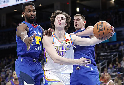 Dec 22, 2021; Oklahoma City, Oklahoma, USA; Oklahoma City Thunder guard Josh Giddey (3) passes the ball around Denver Nuggets forward Jeff Green (32) during the second half at Paycom Center. Oklahoma City won 108-94. Mandatory Credit: Alonzo Adams-USA TODAY Sports