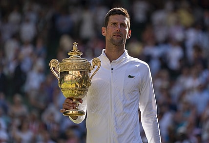 Jul 10, 2022; London, United Kingdom; Novak Djokovic (SRB) poses with the trophy after winning the men   s final against Nick Kyrgios (not pictured) on day 14 at All England Lawn Tennis and Croquet Club. Mandatory Credit: Susan Mullane-USA TODAY Sports