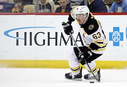 Apr 1, 2023; Pittsburgh, Pennsylvania, USA;  Boston Bruins left wing Brad Marchand (63) skates with the puck against the Pittsburgh Penguins during the third period at PPG Paints Arena. Boston won 4-3. Mandatory Credit: Charles LeClaire-USA TODAY Sports