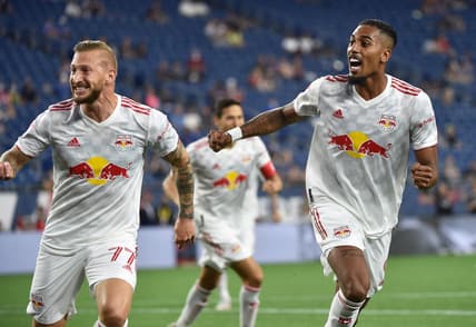 May 22, 2021; Foxborough, Massachusetts, USA;  New York Red Bulls midfielder Daniel Royer (77) and forward Fabio (9) react after a goal by defender Andres Reyes (4) (not pictured) during the first half against the New England Revolution at Gillette Stadium. Mandatory Credit: Bob DeChiara-USA TODAY Sports