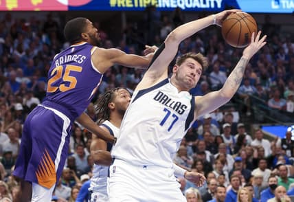 May 6, 2022; Dallas, Texas, USA; Dallas Mavericks guard Luka Doncic (77) grabs a rebound in front of Phoenix Suns forward Mikal Bridges (25)  during the second quarter in game three of the second round of the 2022 NBA playoffs at American Airlines Center. Mandatory Credit: Kevin Jairaj-USA TODAY Sports