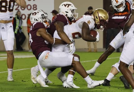 Sep 10, 2022; Blacksburg, Virginia, USA;  Virginia Tech Hokies defensive lineman Jaylen Griffin (top) and Virginia Tech Hokies linebacker Jayden McDonald (38) tackle Boston College Eagles running back Pat Garwo III (24) during the second quarter at Lane Stadium. Mandatory Credit: Reinhold Matay-USA TODAY Sports
