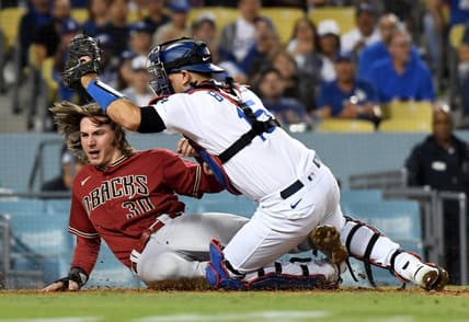 Sep 21, 2022; Los Angeles, California, USA; Arizona Diamondbacks left fielder Jake McCarthy (30) scores in front of Los Angeles Dodgers catcher Austin Barnes (15) during the 7th inning at Dodger Stadium. Mandatory Credit: Richard Mackson-USA TODAY Sports