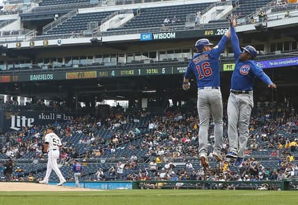 Sep 25, 2022; Pittsburgh, Pennsylvania, USA; Chicago Cubs third baseman Patrick Wisdom (16) celebrates with third base coach Willie Harris (33) after hitting a three-run home run against Pittsburgh Pirates relief pitcher Manny Banuelos (53) during the fifth inning at PNC Park. Mandatory Credit: Charles LeClaire-USA TODAY Sports