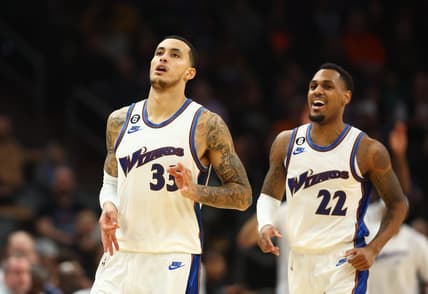 Dec 20, 2022; Phoenix, Arizona, USA; Washington Wizards forward Kyle Kuzma (33) celebrates a three point shot with guard Monte Morris (22) against the Phoenix Suns in the second half at Footprint Center. Mandatory Credit: Mark J. Rebilas-USA TODAY Sports