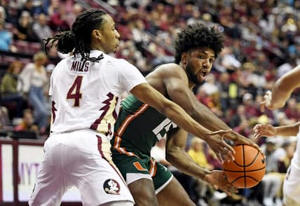 Jan 24, 2023; Tallahassee, Florida, USA; Miami Hurricanes forward Norchad Omier (15) passes the ball around Florida State Seminoles guard Caleb Mills (4) during the first half at Donald L. Tucker Center. Mandatory Credit: Melina Myers-USA TODAY Sports