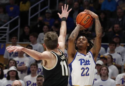 Jan 25, 2023; Pittsburgh, Pennsylvania, USA;  Pittsburgh Panthers guard Nike Sibande (22) shoots a three point basket against Wake Forest Demon Deacons forward Andrew Carr (11) during the first half at the Petersen Events Center. Mandatory Credit: Charles LeClaire-USA TODAY Sports