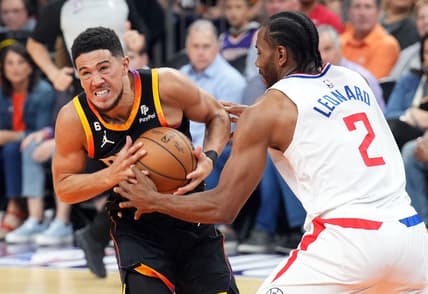 Apr 16, 2023; Phoenix, Arizona, USA; Phoenix Suns guard Devin Booker (1) drives against LA Clippers forward Kawhi Leonard (2) during the first half of game one of the 2023 NBA playoffs at Footprint Center. Mandatory Credit: Joe Camporeale-USA TODAY Sports
