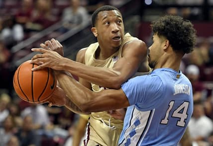 Feb 27, 2023; Tallahassee, Florida, USA; North Carolina Tar Heels forward Donovan Johnson (14) fouls Florida State Seminoles guard Matthew Cleveland (35) during the first half at Donald L. Tucker Center. Mandatory Credit: Melina Myers-USA TODAY Sports