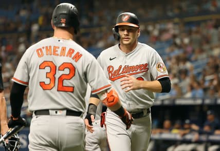 Jun 20, 2023; St. Petersburg, Florida, USA;  Baltimore Orioles third baseman Gunnar Henderson (2) is congratulated by first baseman Ryan O'Hearn (32) after he scored a run against the Tampa Bay Rays during the first inning at Tropicana Field. Mandatory Credit: Kim Klement-USA TODAY Sports