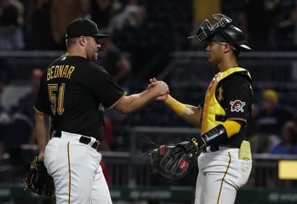 Aug 22, 2023; Pittsburgh, Pennsylvania, USA; Pittsburgh Pirates relief pitcher David Bednar (51) and catcher Endy Rodriguez (25) celebrate after defeating the St. Louis Cardinals at PNC Park. The Pirates won 6-3. Mandatory Credit: Charles LeClaire-USA TODAY Sports
