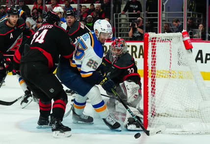 Jan 6, 2024; Raleigh, North Carolina, USA; Carolina Hurricanes goaltender Antti Raanta (32) stops the shot attempt by St. Louis Blues center Jordan Kyrou (25) during the second period at PNC Arena. Mandatory Credit: James Guillory-USA TODAY Sports