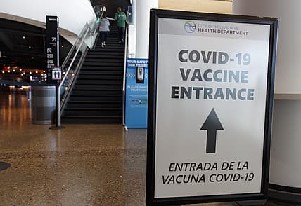 May 2, 2021; Milwaukee, Wisconsin, USA; A sign directing fans where to receive a COVID-19 vaccination prior to the game between the Milwaukee Bucks and the Brooklyn Netsat Fiserv Forum. Mandatory Credit: Jeff Hanisch-USA TODAY Sports