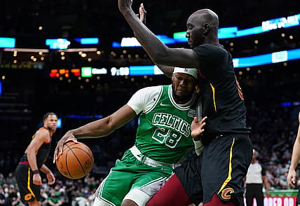 Dec 22, 2021; Boston, Massachusetts, USA; Boston Celtics forward Bruno Fernando (28) drives against Cleveland Cavaliers center Tacko Fall (99) in the second half at TD Garden. Mandatory Credit: David Butler II-USA TODAY Sports