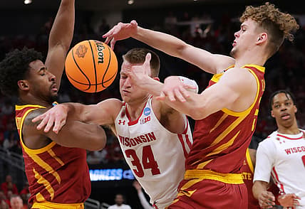 Mar 20, 2022; Milwaukee, WI, USA; Wisconsin Badgers guard Brad Davison (34) drives between Iowa State Cyclones guard Izaiah Brockington (left) and forward Aljaz Kunc (right) in the second half  during the second round of the 2022 NCAA Tournament at Fiserv Forum. Mandatory Credit: Mark Hoffman/Milwaukee Journal Sentinel via USA TODAY NETWORK
