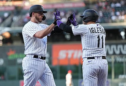 Aug 9, 2022; Denver, Colorado, USA; Colorado Rockies first baseman C.J. Cron (25) celebrates his three run home run with shortstop Jose Iglesias (11) in the first inning against the St. Louis Cardinals at Coors Field. Mandatory Credit: Ron Chenoy-USA TODAY Sports