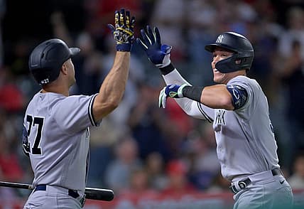 Aug 29, 2022; Anaheim, California, USA;  New York Yankees right fielder Aaron Judge (99) is congratulated by designated hitter Giancarlo Stanton (27) after hitting his 50th home run of the season in the eighth inning against the Los Angeles Angels at Angel Stadium. Mandatory Credit: Jayne Kamin-Oncea-USA TODAY Sports