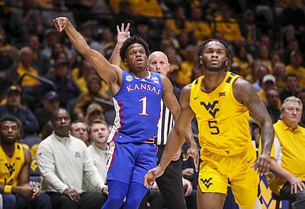 Jan 7, 2023; Morgantown, West Virginia, USA; Kansas Jayhawks guard Joseph Yesufu (1) shoots a three point basket over West Virginia Mountaineers guard Joe Toussaint (5) during the first half at WVU Coliseum. Mandatory Credit: Ben Queen-USA TODAY Sports