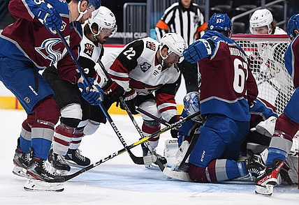 Apr 12, 2021; Denver, Colorado, USA; Arizona Coyotes left wing Johan Larsson (22) and right wing Conor Garland (83) attempt to score against Colorado Avalanche goaltender Philipp Grubauer (31) and defenseman Keaton Middleton (67) in the first period at Ball Arena. Mandatory Credit: Ron Chenoy-USA TODAY Sports