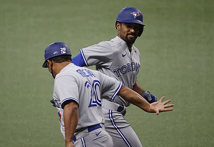 Apr 23, 2021; St. Petersburg, Florida, USA; Toronto Blue Jays shortstop Marcus Semien (R) is congratulated after hitting a three-run home run during the first inning against the Tampa Bay Rays at Tropicana Field. Mandatory Credit: Kim Klement-USA TODAY Sports