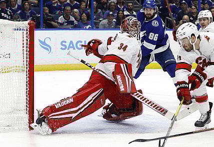 Jun 5, 2021; Tampa, Florida, USA; Carolina Hurricanes goaltender Petr Mrazek (34) makes a save against the Tampa Bay Lightning during the first period in game four of the second round of the 2021 Stanley Cup Playoffs at Amalie Arena. Mandatory Credit: Kim Klement-USA TODAY Sports
