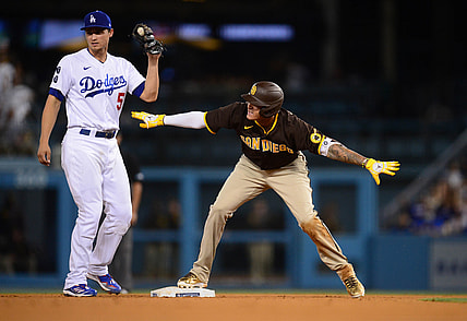 September 11, 2021; Los Angeles, California, USA; San Diego Padres third baseman Manny Machado (13) reacts after reaching second against Los Angeles Dodgers shortstop Corey Seager (5) on a double hit during the sixth inning at Dodger Stadium. Mandatory Credit: Gary A. Vasquez-USA TODAY Sports