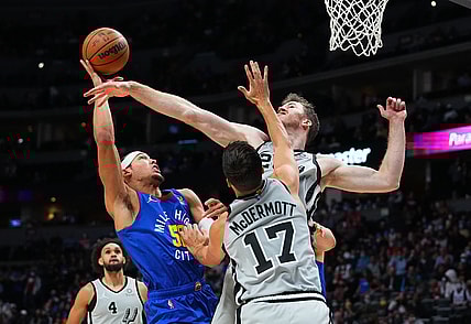 Oct 22, 2021; Denver, Colorado, USA; Denver Nuggets forward Aaron Gordon (50) shoots the ball at San Antonio Spurs center Jakob Poeltl (25) and forward Doug McDermott (17) in the first quarter at Ball Arena. Mandatory Credit: Ron Chenoy-USA TODAY Sports