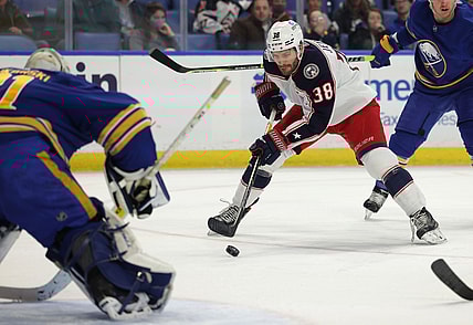Nov 22, 2021; Buffalo, New York, USA;  Columbus Blue Jackets center Boone Jenner (38) moves in for a shot on Buffalo Sabres goaltender Dustin Tokarski (31) during the first period at KeyBank Center. Mandatory Credit: Timothy T. Ludwig-USA TODAY Sports