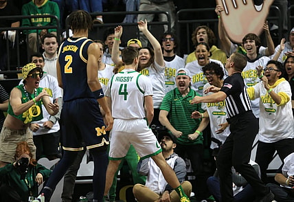 Oregon   s Brennan Rigsby, center, celebrates with Duck fans during the first half of their game against Michigan at Matthew Knight Arena in Eugene Saturday, Dec 2, 2023.