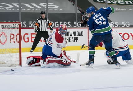 Mar 8, 2021; Vancouver, British Columbia, CAN; Vancouver Canucks forward Bo Horvat (53) and Montreal Canadiens goalie Carey Price (31) watch the rebound in the third period at Rogers Arena. Canucks won 2-1 in an overtime shootout. Mandatory Credit: Bob Frid-USA TODAY Sports